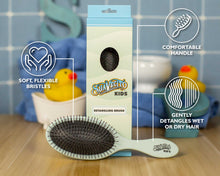 Load image into Gallery viewer, Suavecito Kids detangling brush with packaging and features on a wooden surface.
