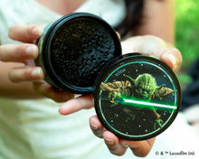 hands holding open jar of Yoda Firme old Pomade